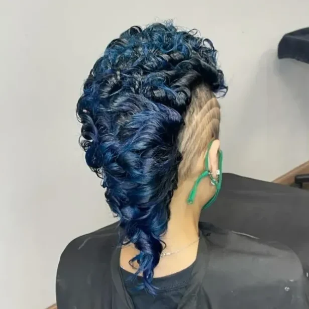 Blue pin curls swept over a shaved, sculpted side